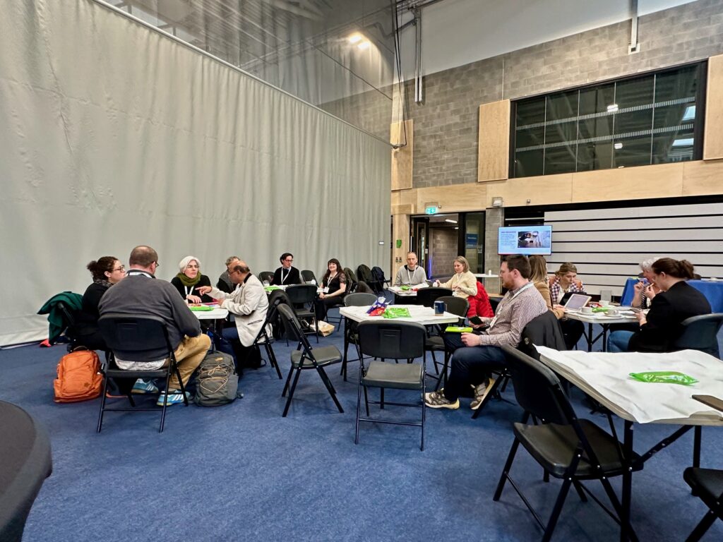 Workshop participants working at their tables collaboratively