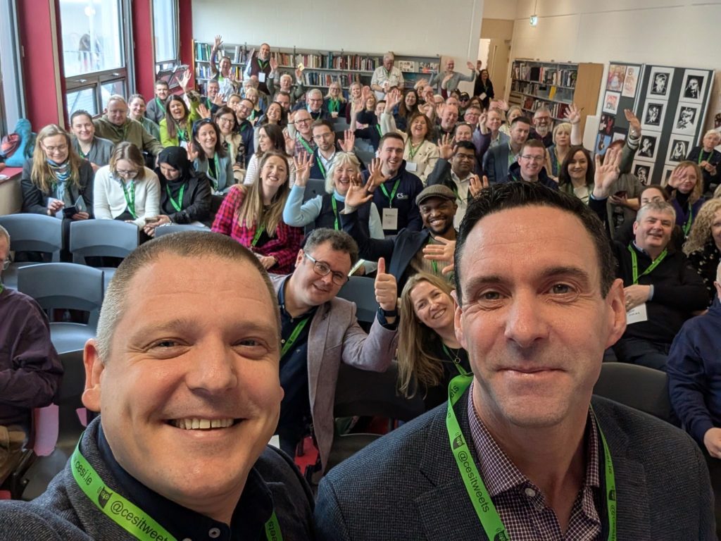 Peter and Enda take a selfie in front of their keynote audience at the 2025 CESI conference